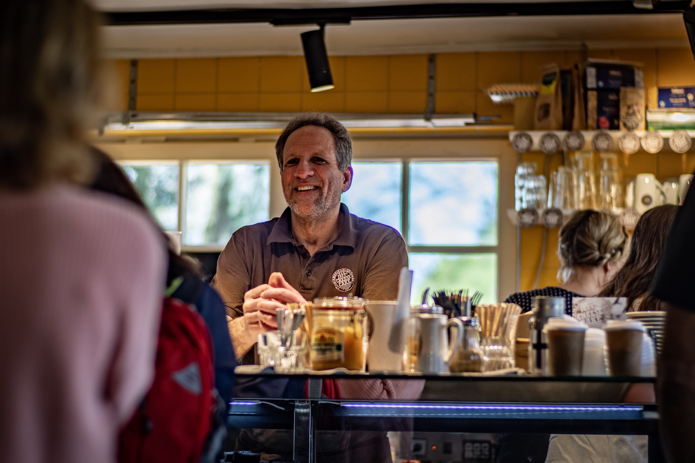 Jeff Alpert smiling in his Café